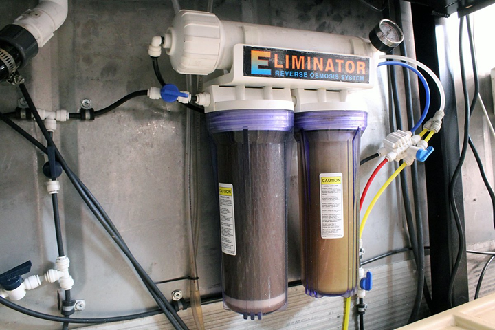 A reverse osmosis system located inside a hydroponic container farm.